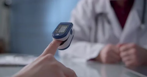 Close-up view of a pulse oximeter used on a patient during an appointment at a Stock Footage 148038253