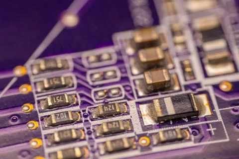 Close-up view of a purple printed circuit board featuring various electroni.. Stock Photos