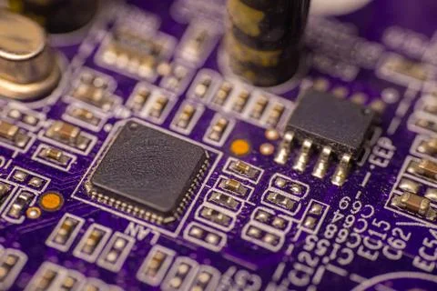 Close-up view of a purple printed circuit board featuring various electroni.. Stock Photos