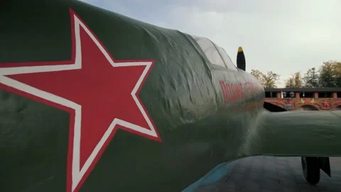 A close up view on the pursuit plane, fighter with a red star monument , WW2 Stock Footage 148210668