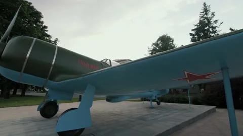 A close up view on the pursuit plane, fighter with a red star monument , WW2 Stock Footage 148210835