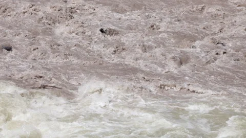 Close View Of A Raging River, Its Murky Brown Water Churning Violently Stock Footage 312959077