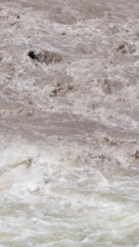 Close View Of A Raging River, Its Murky Brown Water Churning Violently And Creat Stock Footage 318497859