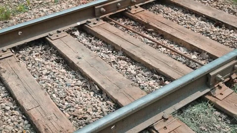 Close-up view of railroad tracks featuring wooden ties and gravel. Stock Footage 339096018