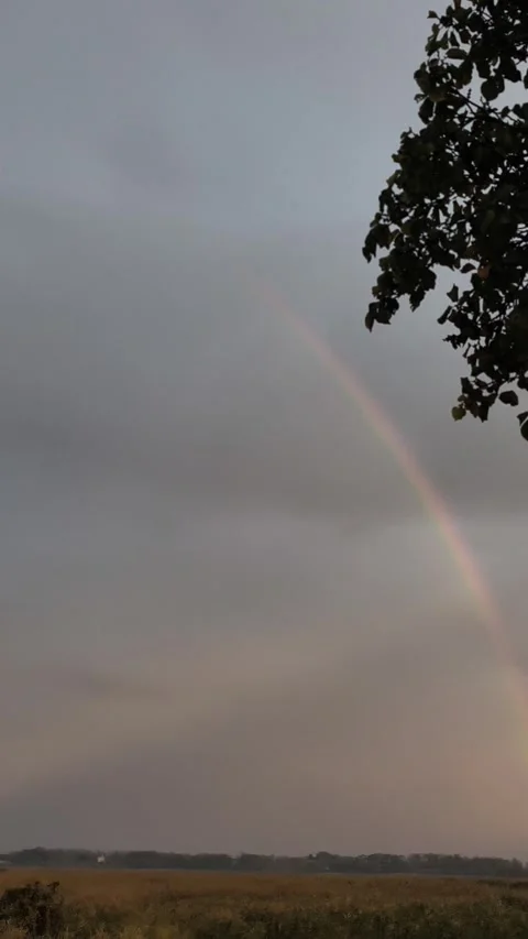 Close view of rainbow glowing through soft clouds. Natural light and color Stock Footage 332396852