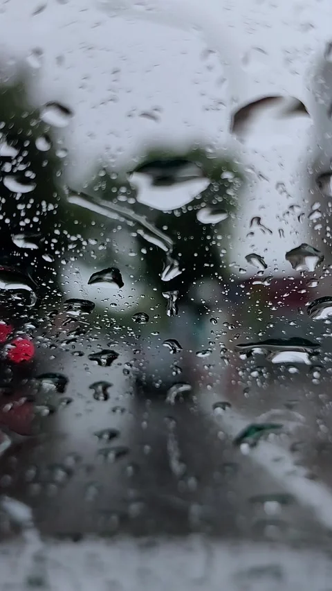 Close up view of raindrops on car window with blurred lights of other cars .. Stock Footage 301138089