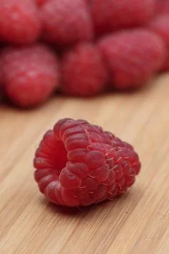 Close-up view of raspberry lying on wooden board Stock Photos