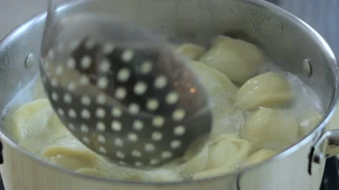 Close-up view on ravioli cooking in boiling water Stock Footage 147433132
