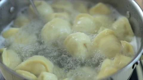 Close-up view on ravioli cooking in boiling water Stock Footage 147433134
