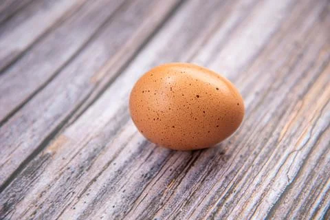 Close-up view of raw chicken eggs on wooden background. Eggs are often said t Foto stock