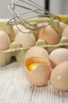 Close-up view of raw chicken eggs in egg box on wooden background. Raw chicke Stock Photos