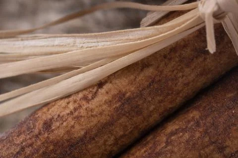 Close-up view of raw cinnamon bark and raffia sling Stock Photos