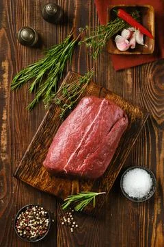 Close-up view of raw fresh beef flat iron steak on wooden table Stock Photos
