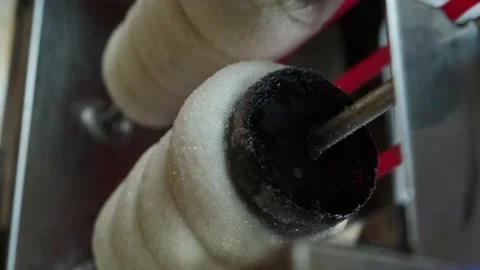 Close view of raw trdelnik, a spit cake, cooking in a store. Cooking in the oven Vidéo 146509931