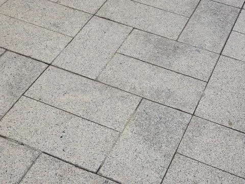 Close up view of rectangular grey stone paver sidewalk Stock Photos