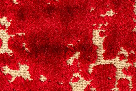 Close-up view of red and beige textured fabric with a distressed pattern Stock Photos