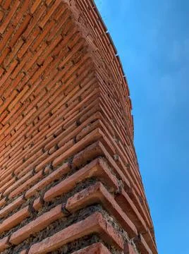 Close up view of red brick column and arch of The ruins of the Red Church. Stock Photos