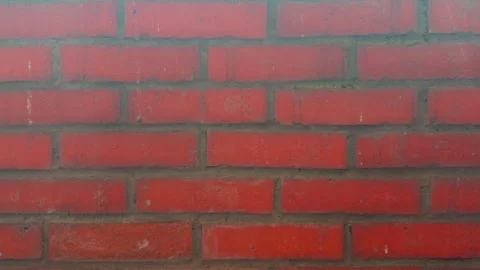 A close-up view of a red brick wall with a textured surface background Stock Footage 318398645