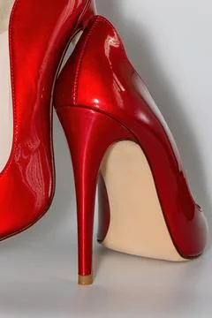 Close up view of the red colored high heeled women's shoes. Stock Photos