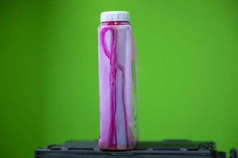 Close up view of red colored ink bottle which is used in color printer 스톡 사진