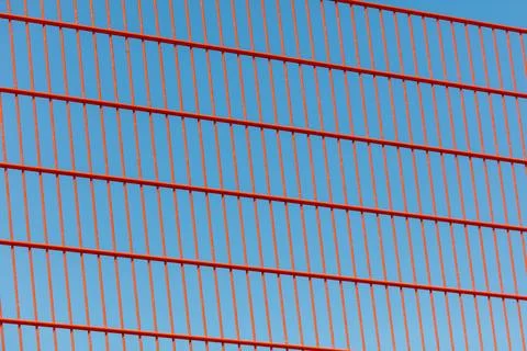 Close-up view of red fence structure in bright daylight Stock Photos