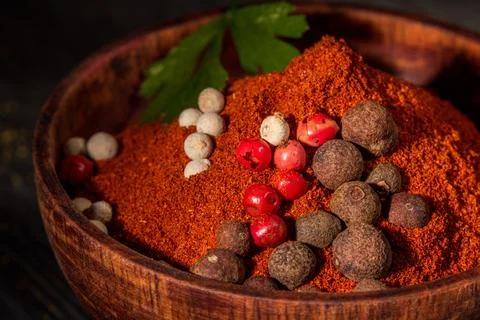 Close-up view of red ground pepper in a rustic wooden bowl for culinary use Stock Photos