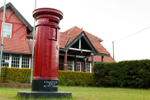 Close up view of red mailbox and post office building Nuwara Eliya, Sri Lanka. Stock Photos
