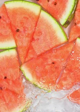 Close up view of the red melon slices in lemonade background. Texture of cooling Stock-Fotos