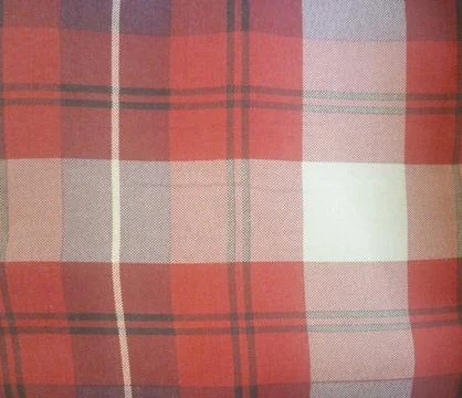 A close-up view of a red plaid pattern fabric featuring varied shades and Stock Photos