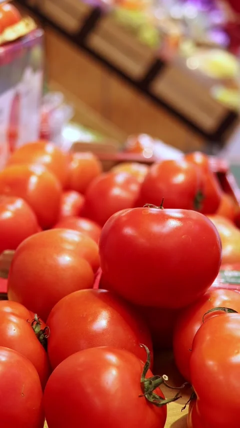 Close-up view of red ripe tomatoes stacked in a grocery shop Stock Footage 324874154