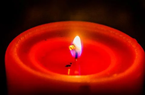 Close up View of a Red Single Thick Candle Burning on a Black Background Stock Photos