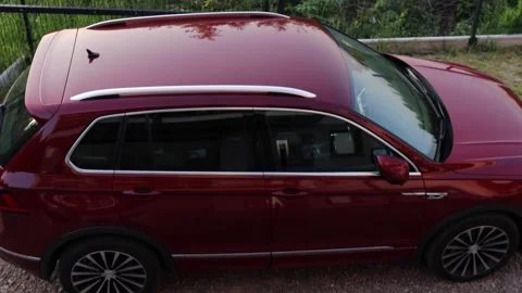 Close up view of a red suv parked on a driveway at sunset captured from abo.. Stock Footage 313451803