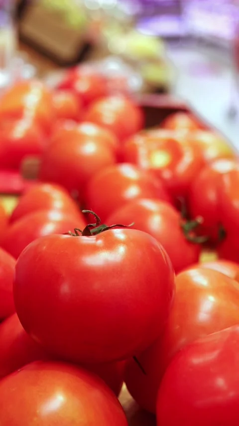 Close-up view of red tomatoes stacked in a grocery store Stock Footage 324874107