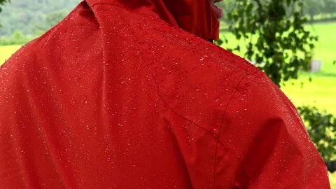 Close View of Red Waterproof Hiking Jacket With Rain Droplets Stock Footage 340306302