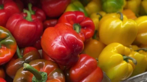 Close-up view of red, yellow, and green bell peppers on shelf Stock Footage 314098096
