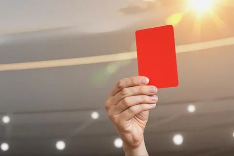 Close-up view on referee hand showing red card in soccer stadium. Stock Photos