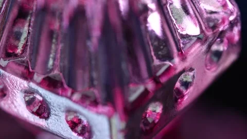 Close view of a reflective glass object with colored light Stock Footage 328665217