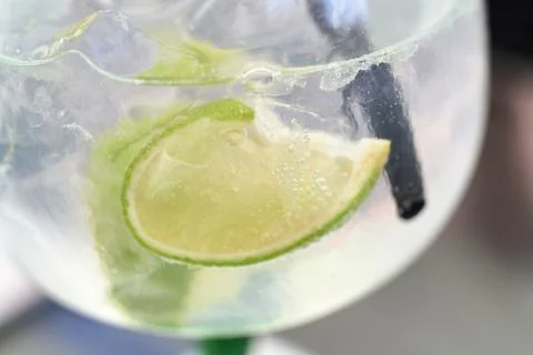 Close-up view of a refreshing gin and tonic cocktail with lime and ice Stock Photos