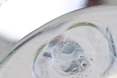 Close-up view of a refreshing gin and tonic cocktail glass with melting ice.. Stock Photos