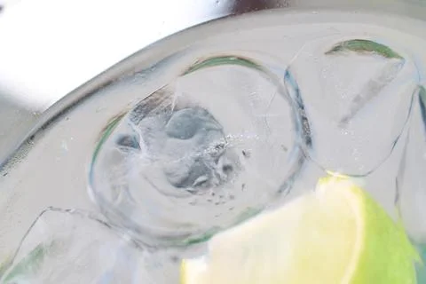 Close-up view of a refreshing gin and tonic cocktail with ice and lime 스톡 사진