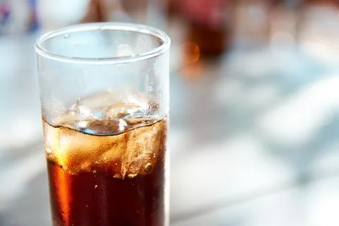 Close-up view of a refreshing glass of dark cola beverage with ice cubes Stock Photos