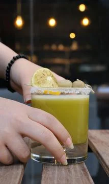 Close-up view of a refreshing green beverage garnished with lemon slices Stock Photos