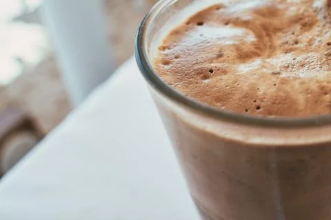 Close-up view of refreshing iced coffee with thick foam in a tall glass Stock Photos