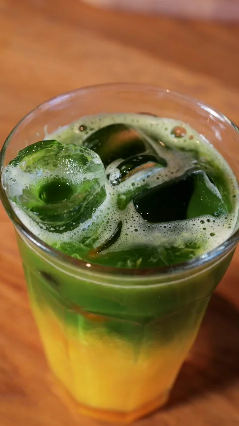 A close up view of a refreshing layered drink with green and yellow colors .. Stock Footage 339373310