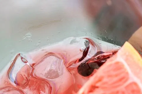 Close-up view of a refreshing pink gin cocktail with ice cubes and grapefru.. Stock Photos