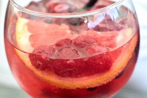 Close-up view of a refreshing pink gin cocktail with fresh raspberries and .. Stock Photos