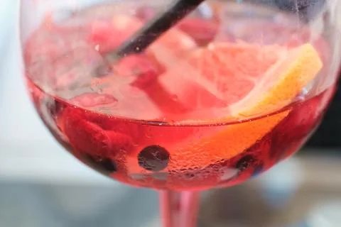 Close-up view of a refreshing pink gin cocktail with fresh fruit and ice Stock Photos