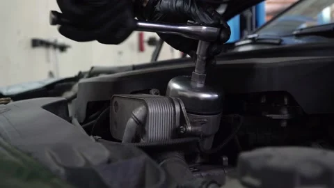 Close-up view of Repairman changes engine oil filter Stock Footage 120950659