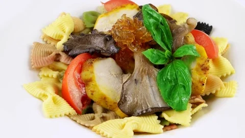 Close-up view of Restaurant bowtie pasta, chicken, oyster mushrooms Stock Footage 73654619