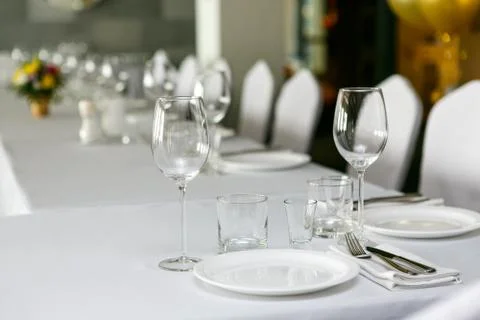 A close up view of restaurant table set with wine glasses Stock Photos
